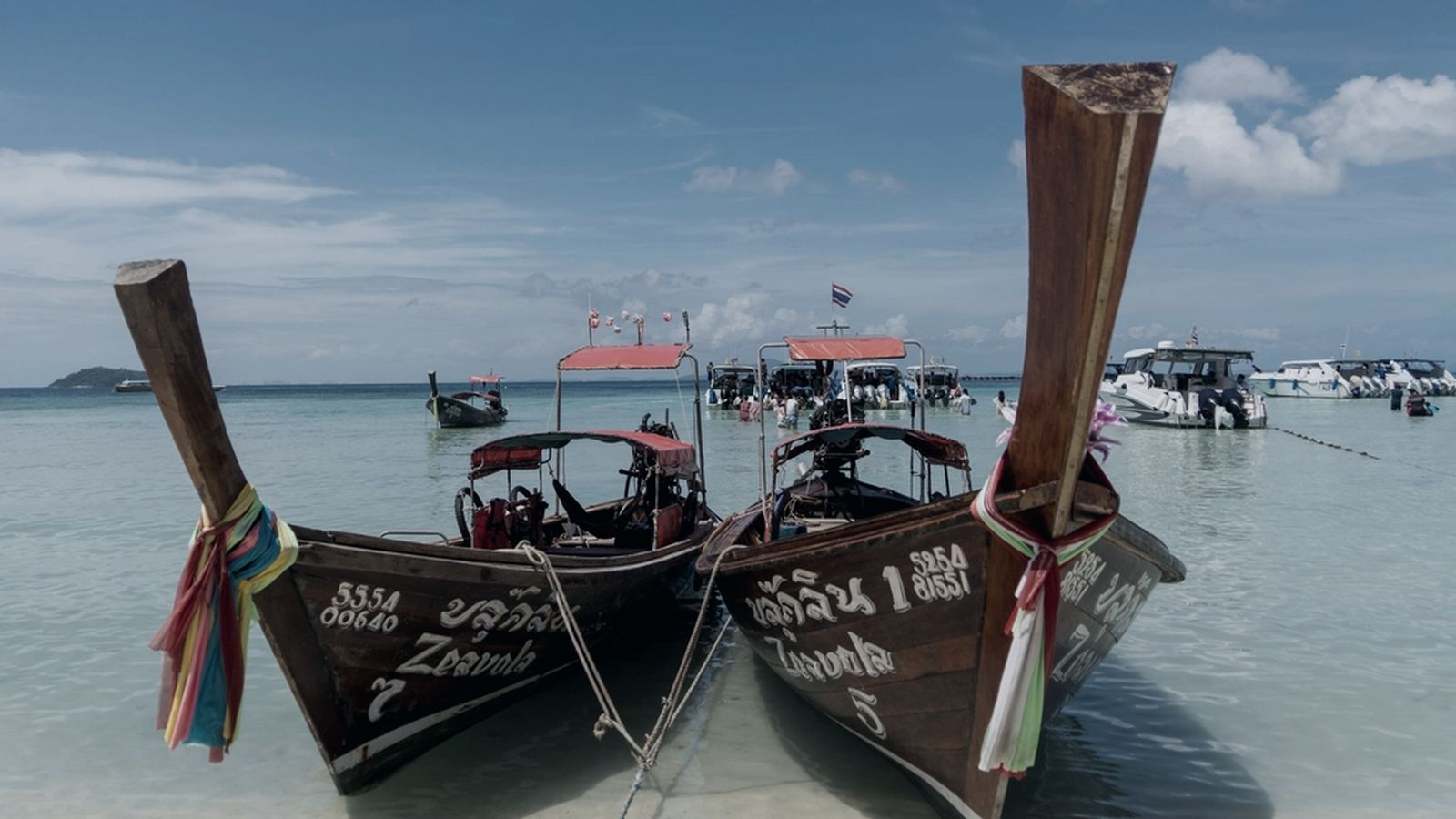Long-tail tour boats waiting at the pier on Thailand's Andaman coast