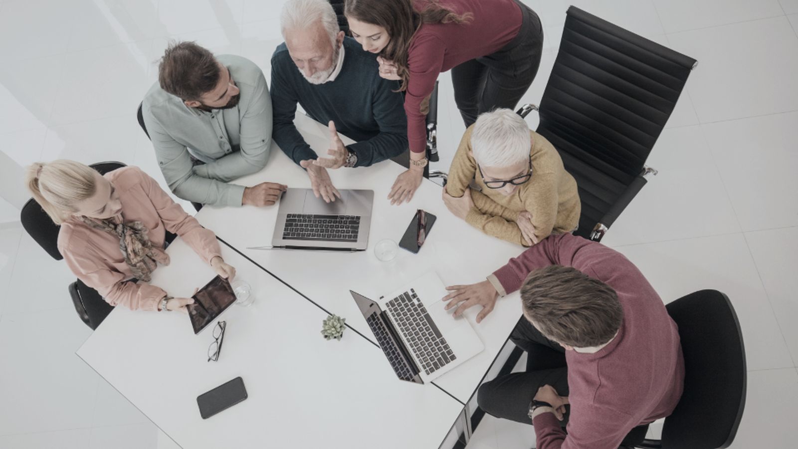 A tourism management team reviewing performance around a table